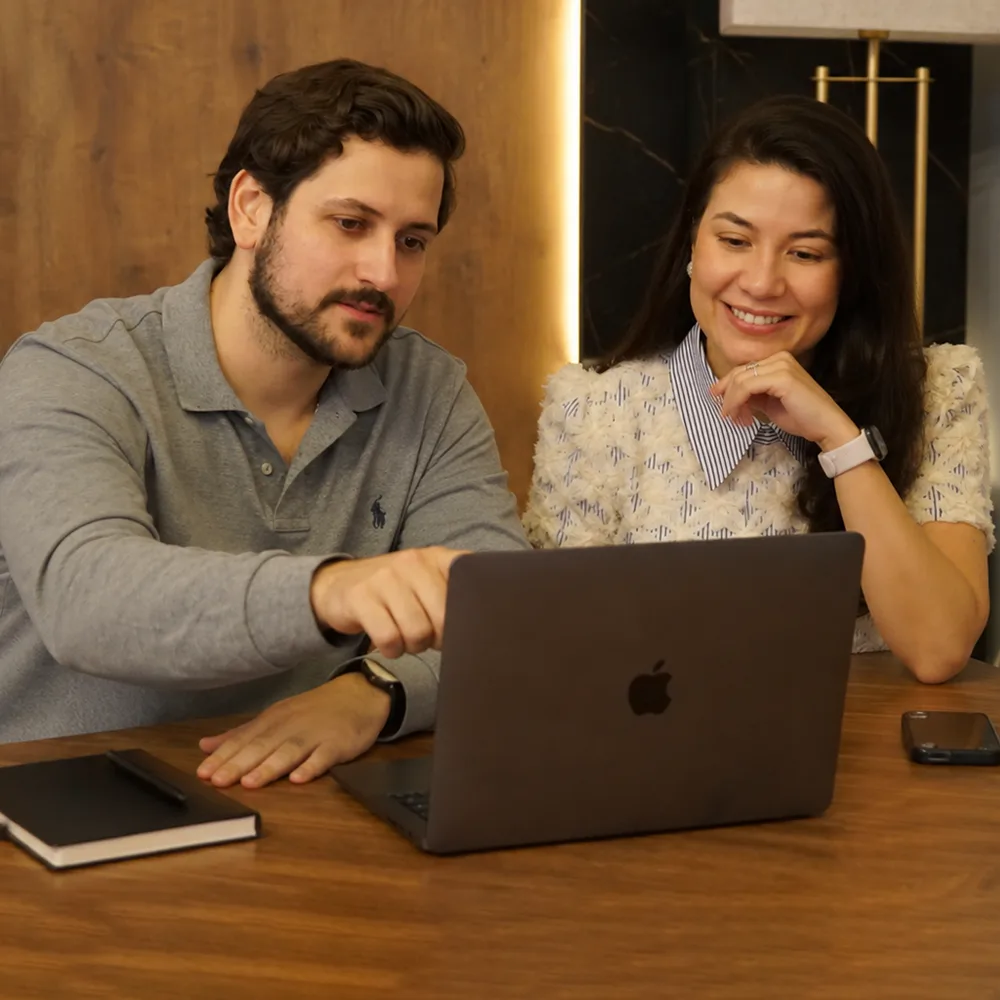 Filemon and Kalita, GetNuva founders, working together at a laptop